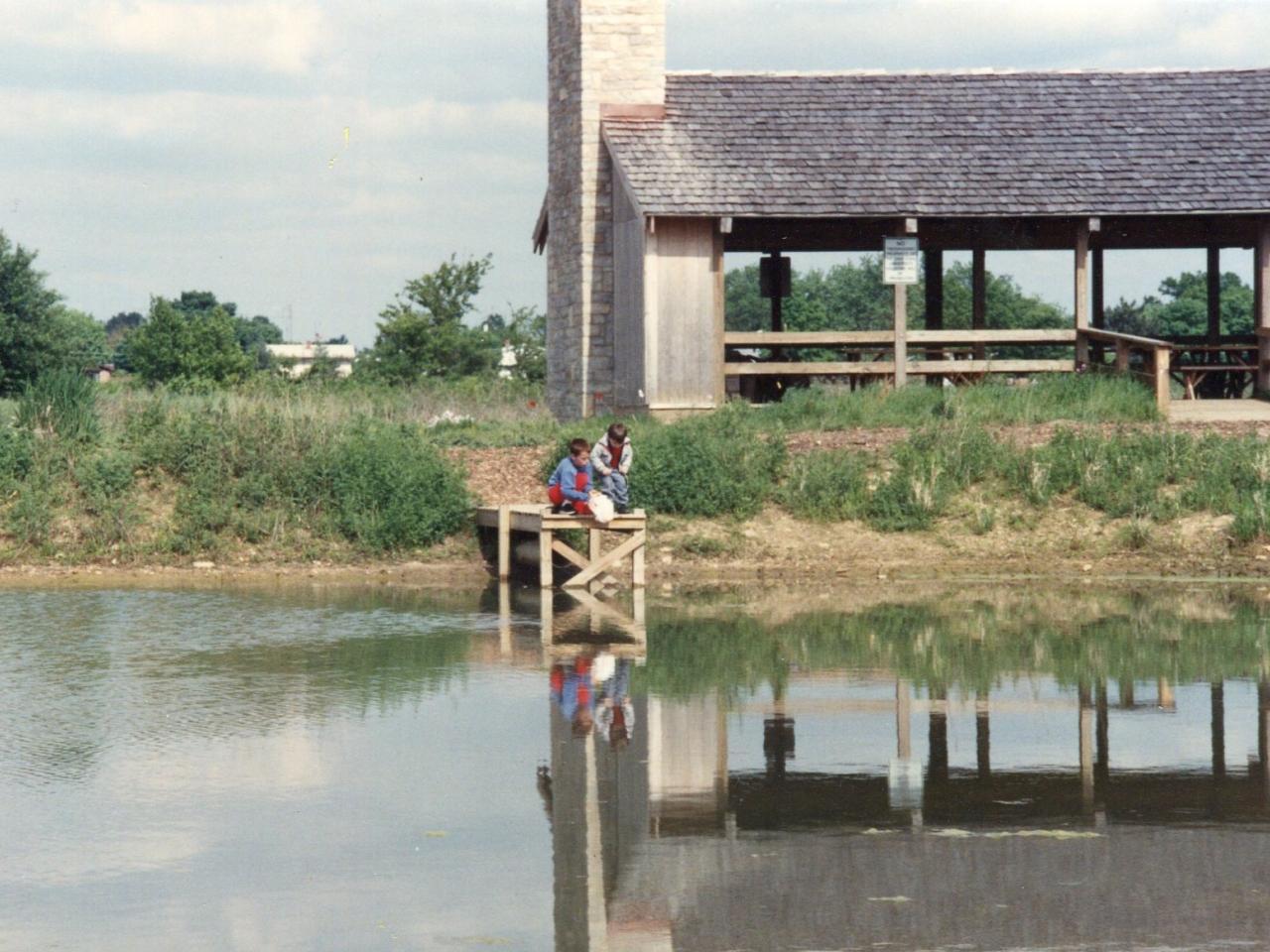 two children playing by the pond