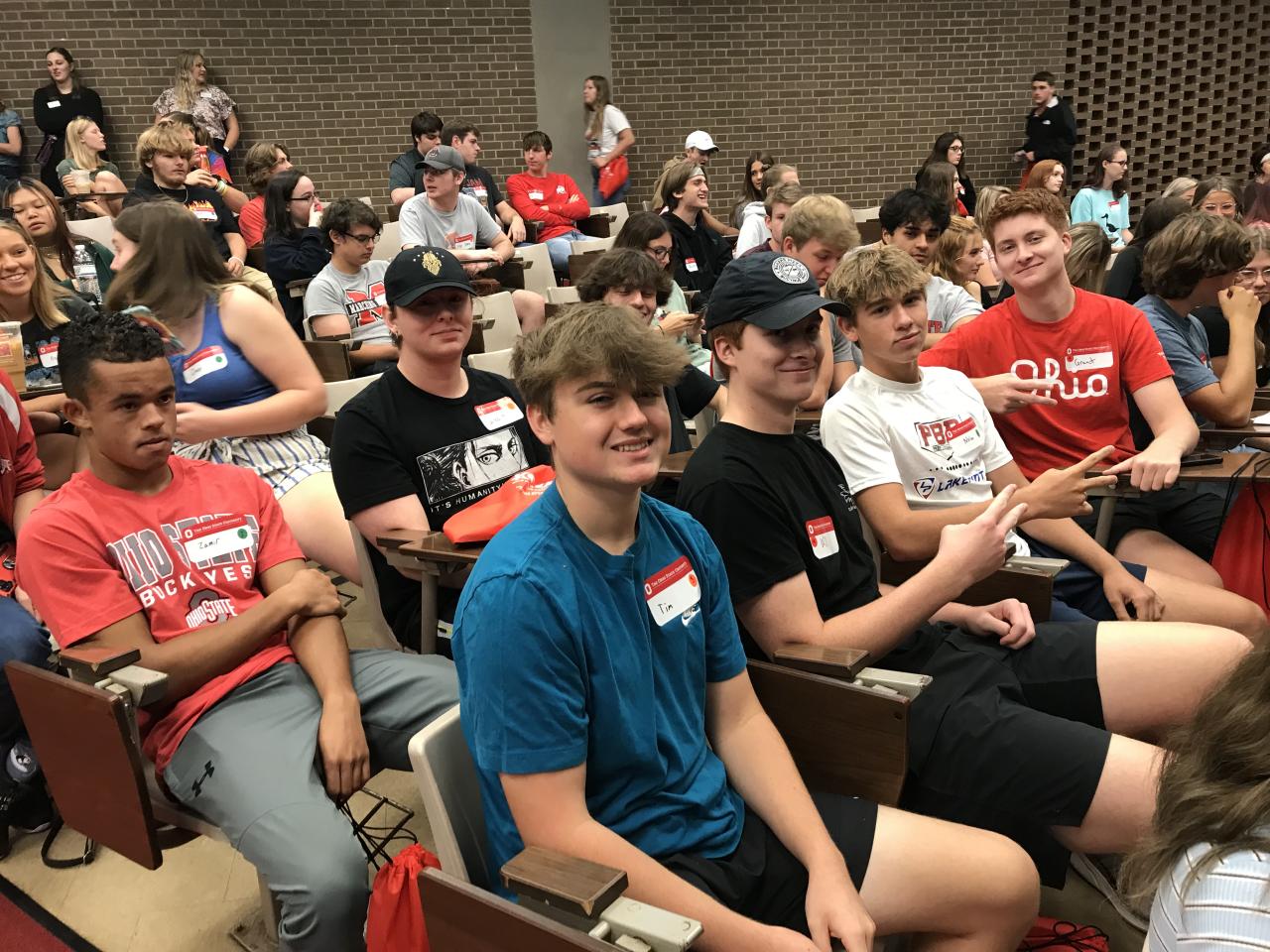 Male students seated in auditorium