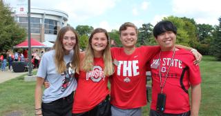 four students of The Ohio State University at Marion posing for photo in front of a Welcome Week event