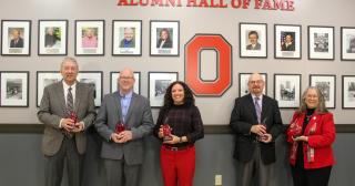 new members pictured in front of Ohio State Marion Alumni Hall of Fame wall