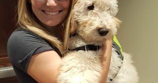 Juneau, a four month old female golden-doodle, and her handler, second year animal science major Alexis Nicholson