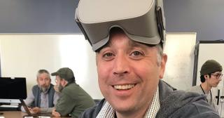Jeffrey Kuhn smiling for picture with virtual reality headset on