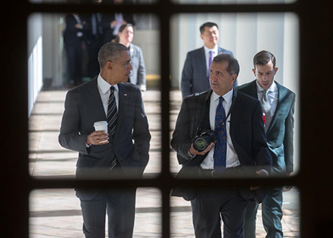 Photo of President Obama walking with photographer