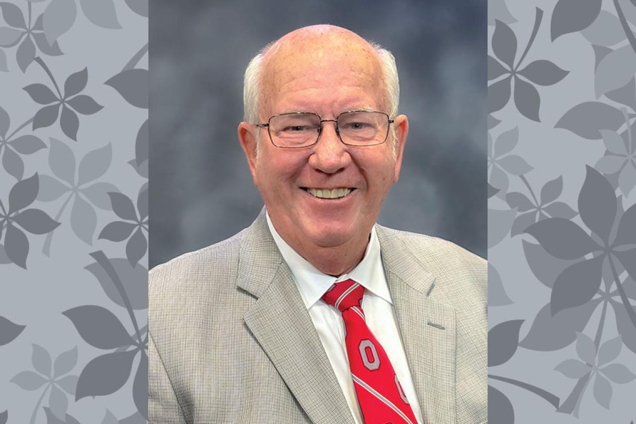 man in suit and tie, glasses smiling professional head shot