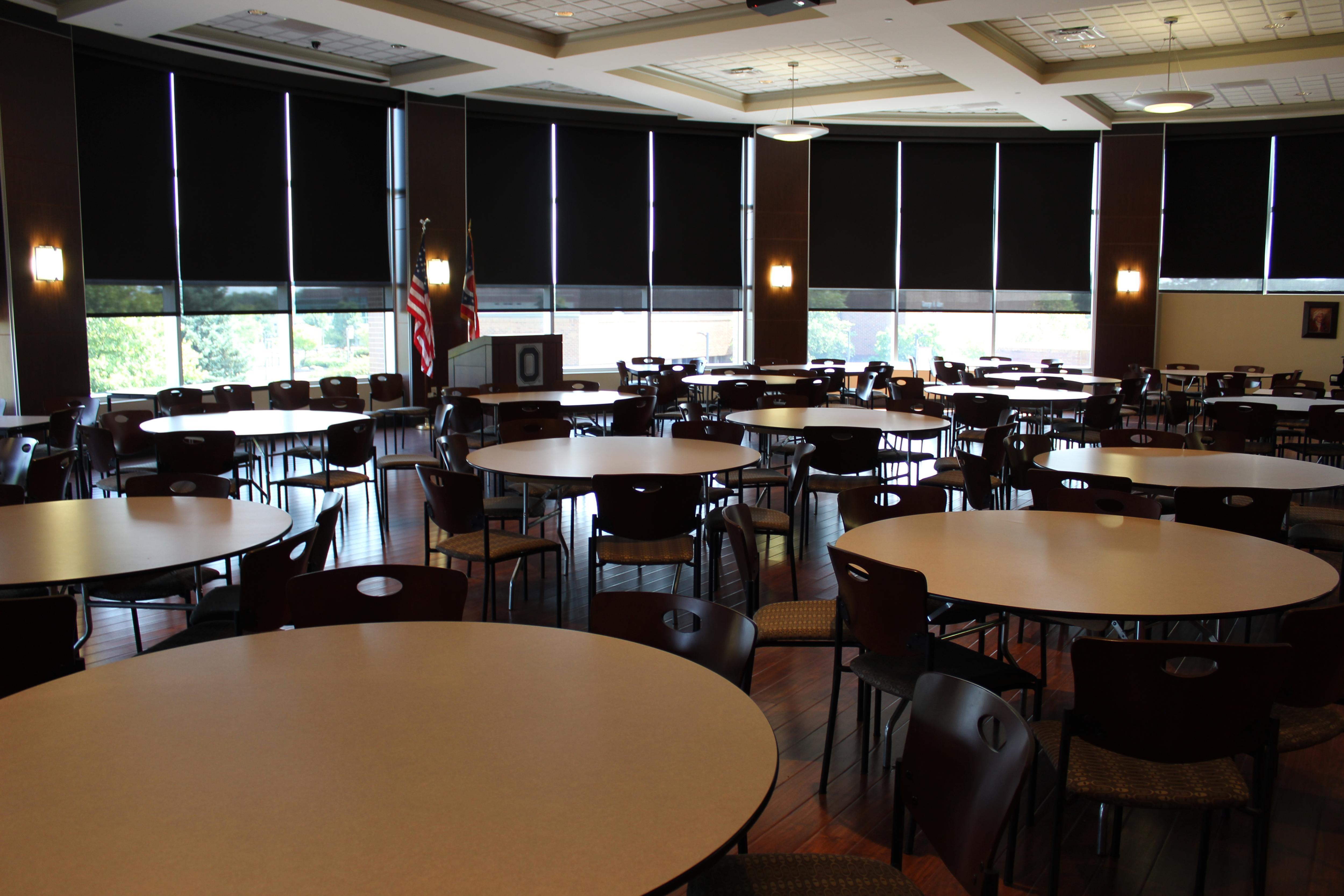 room with multiple tables and large windows