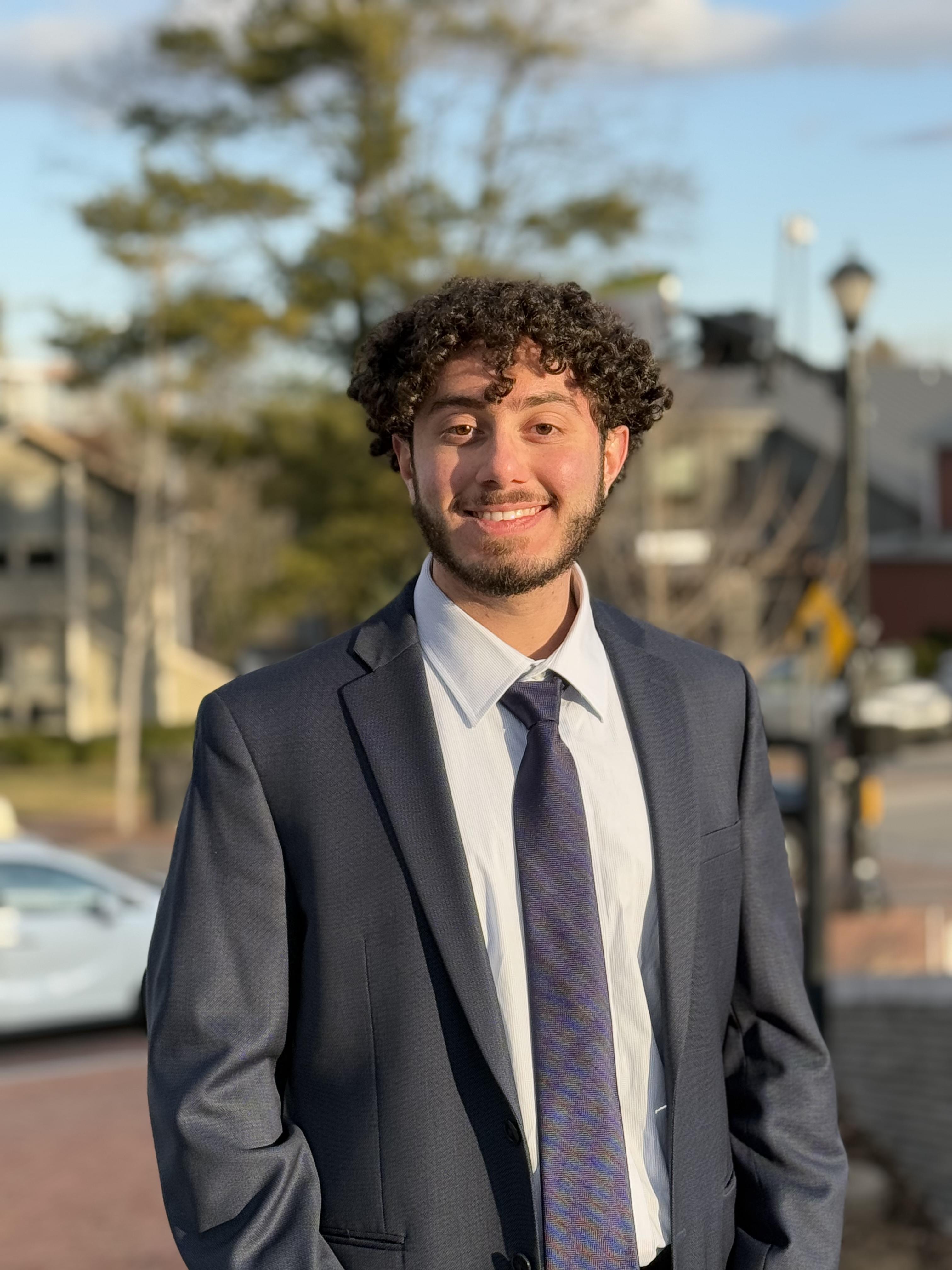 young man in suit and tie in suburban neigborhood