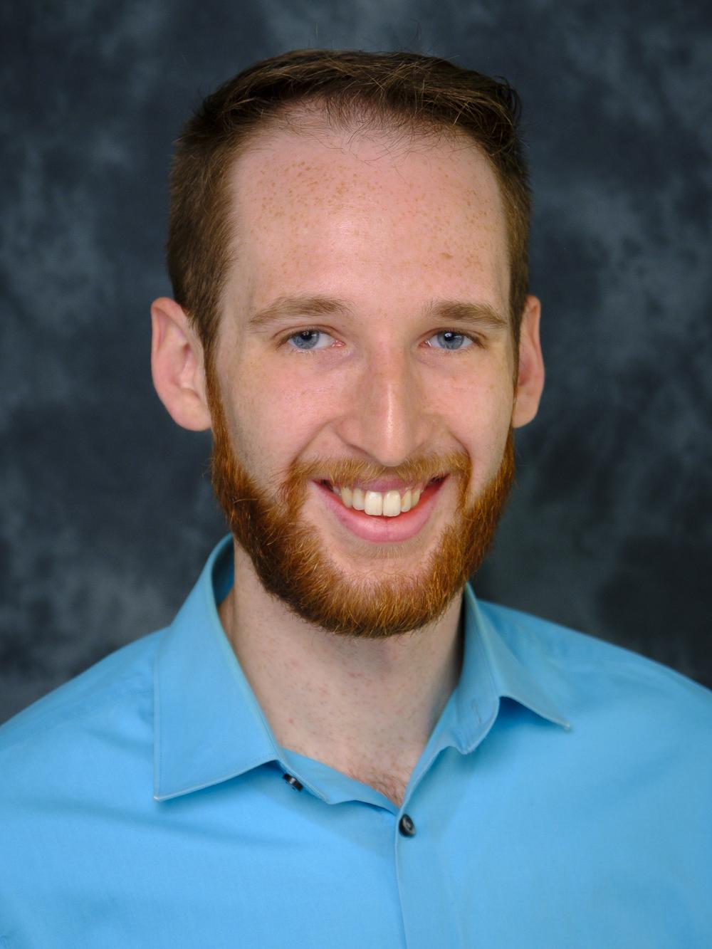 man with beard and mustached in blue shirt photo background
