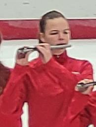 woman playing piccolo in ice rink