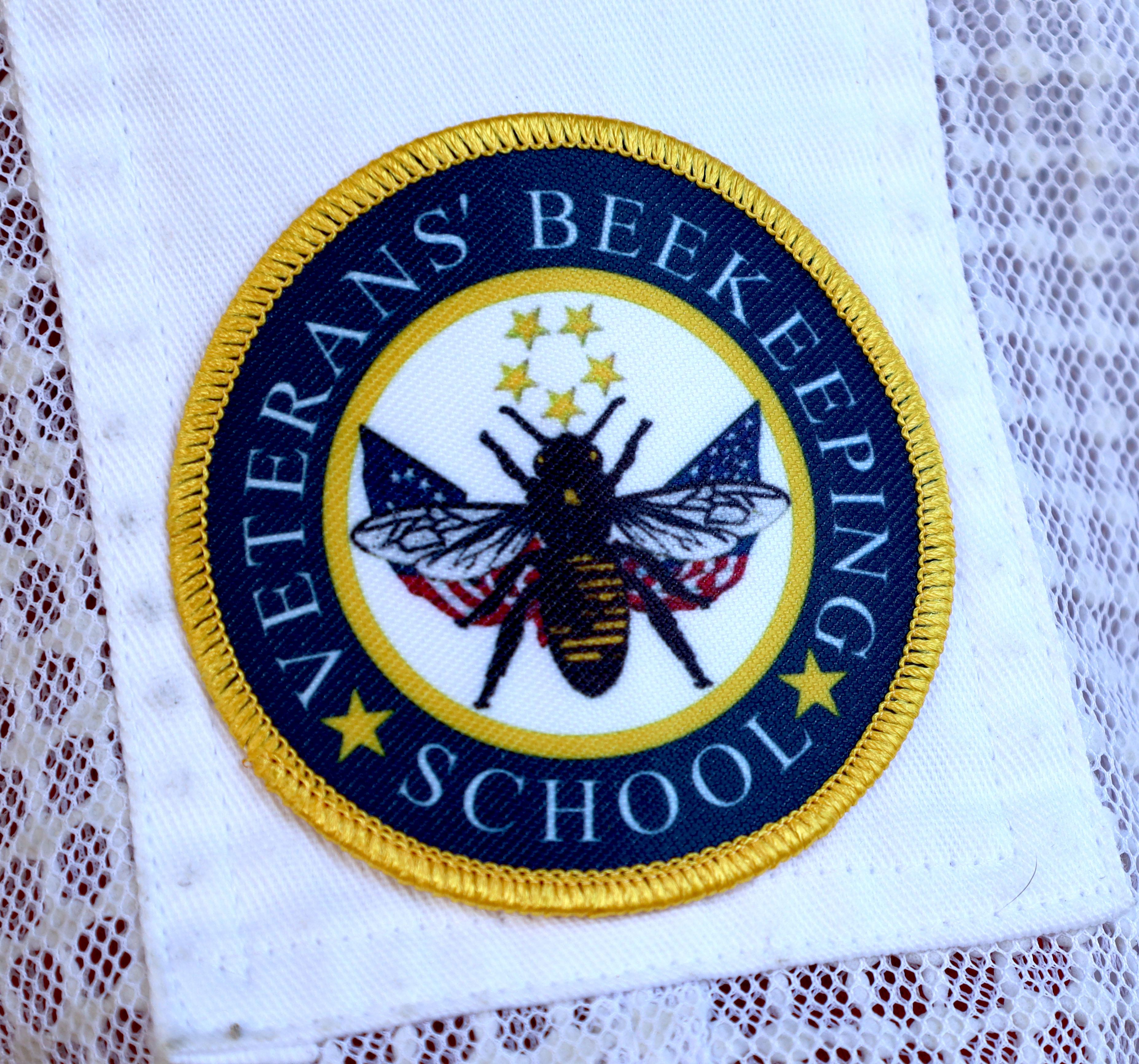 patch on bee keeper uniform reads Veterans Beekeeping School