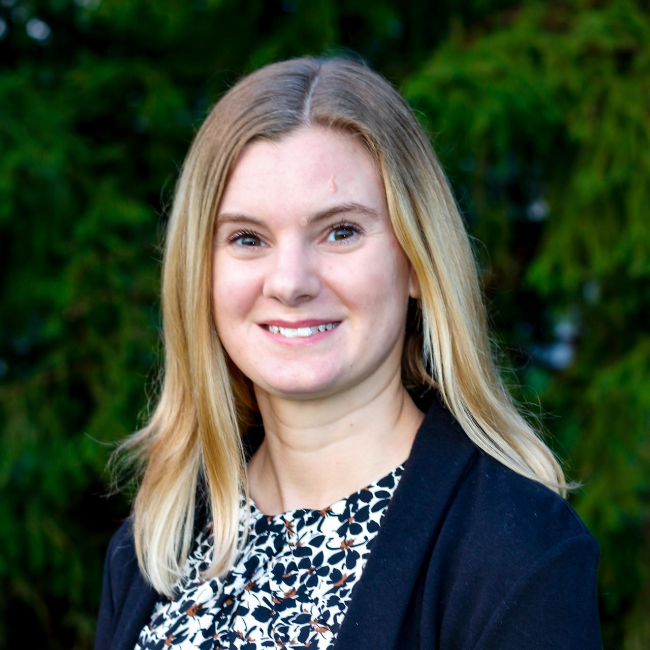woman smiling with trees in background