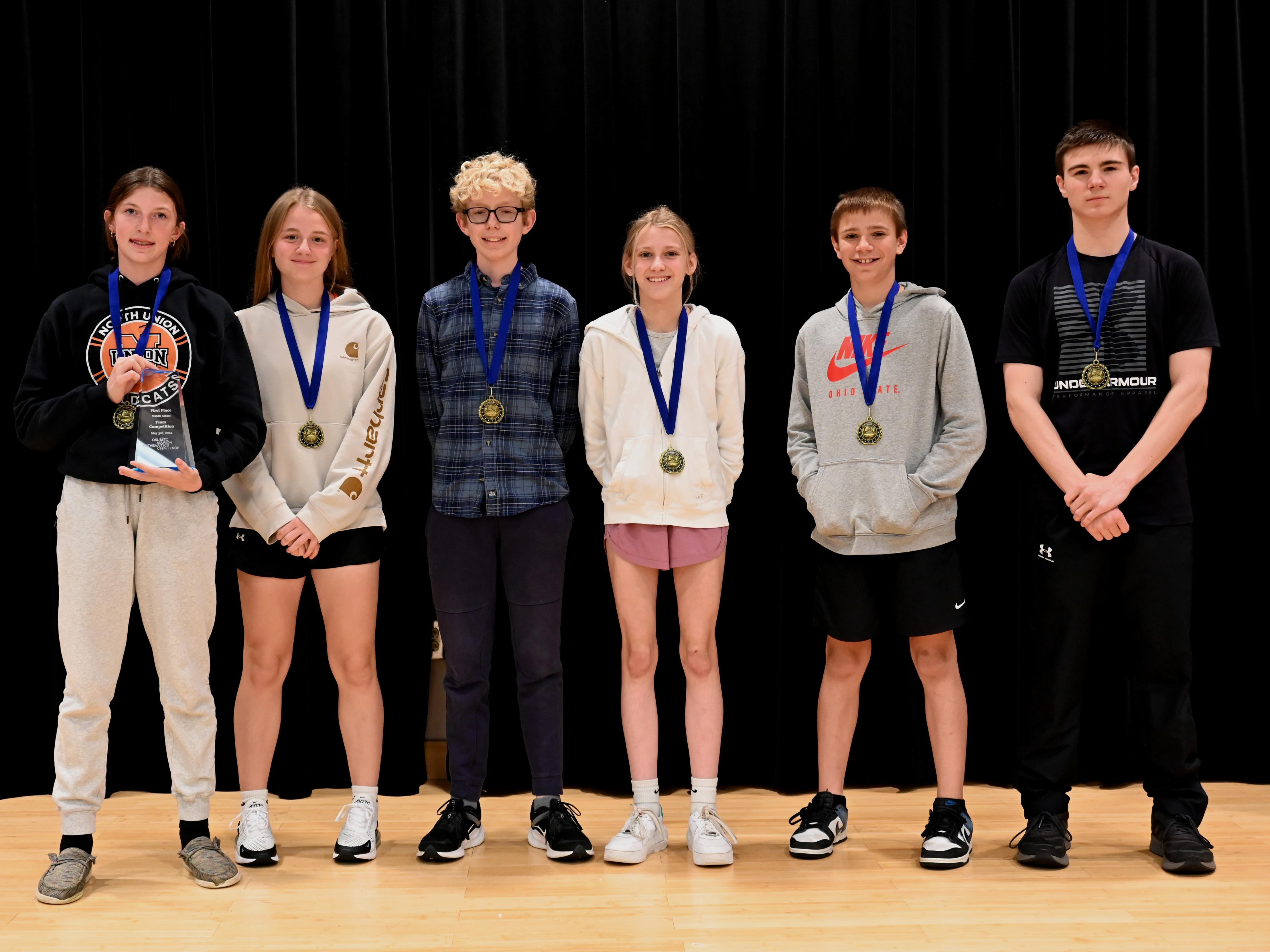 six students with medals