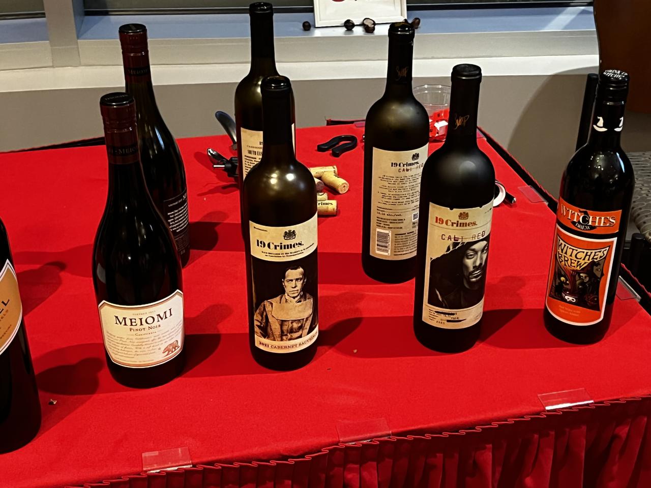 8 bottles of wine on a red table cloth