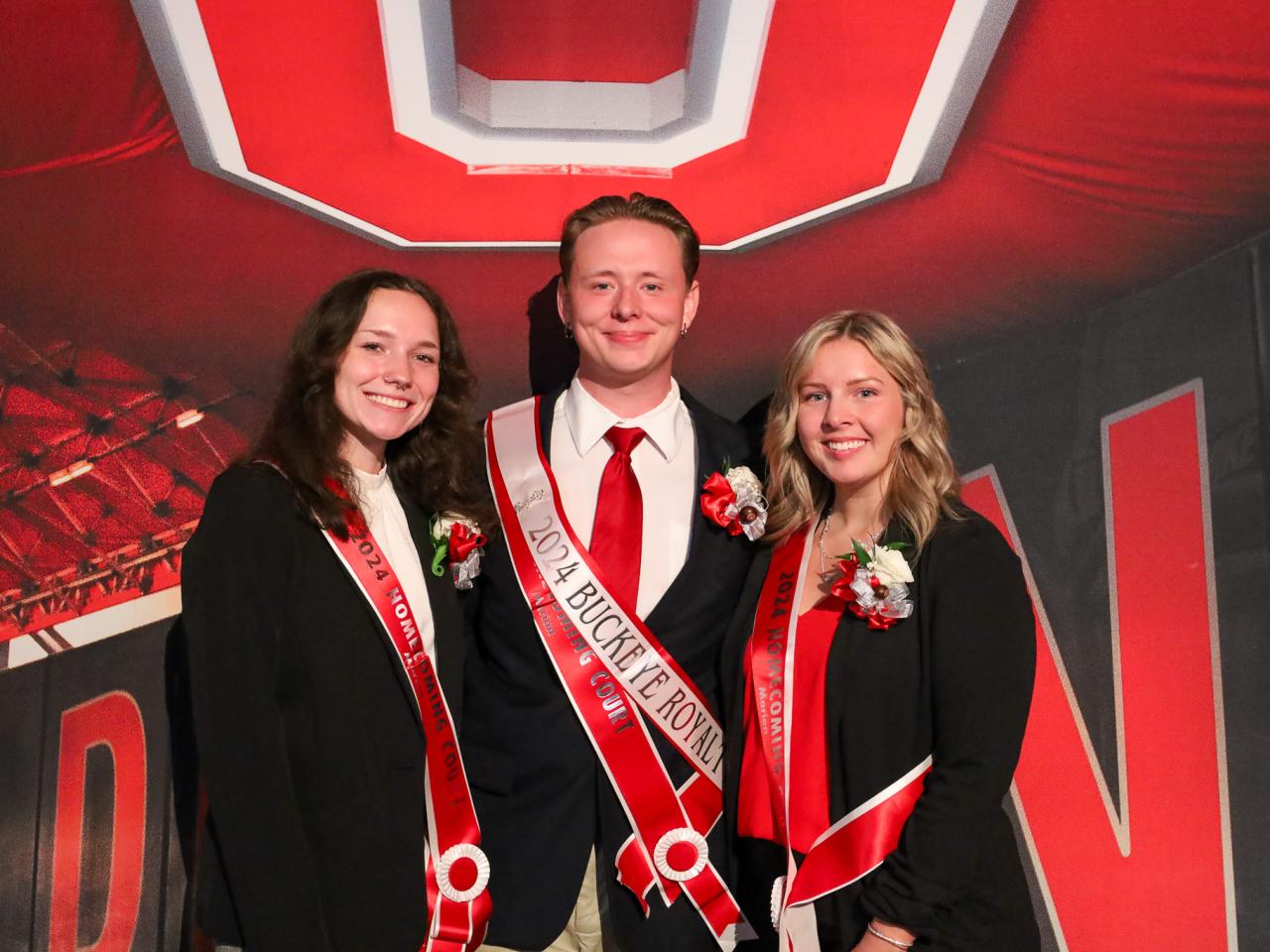 students with sashes in stadium tunnel, block o above