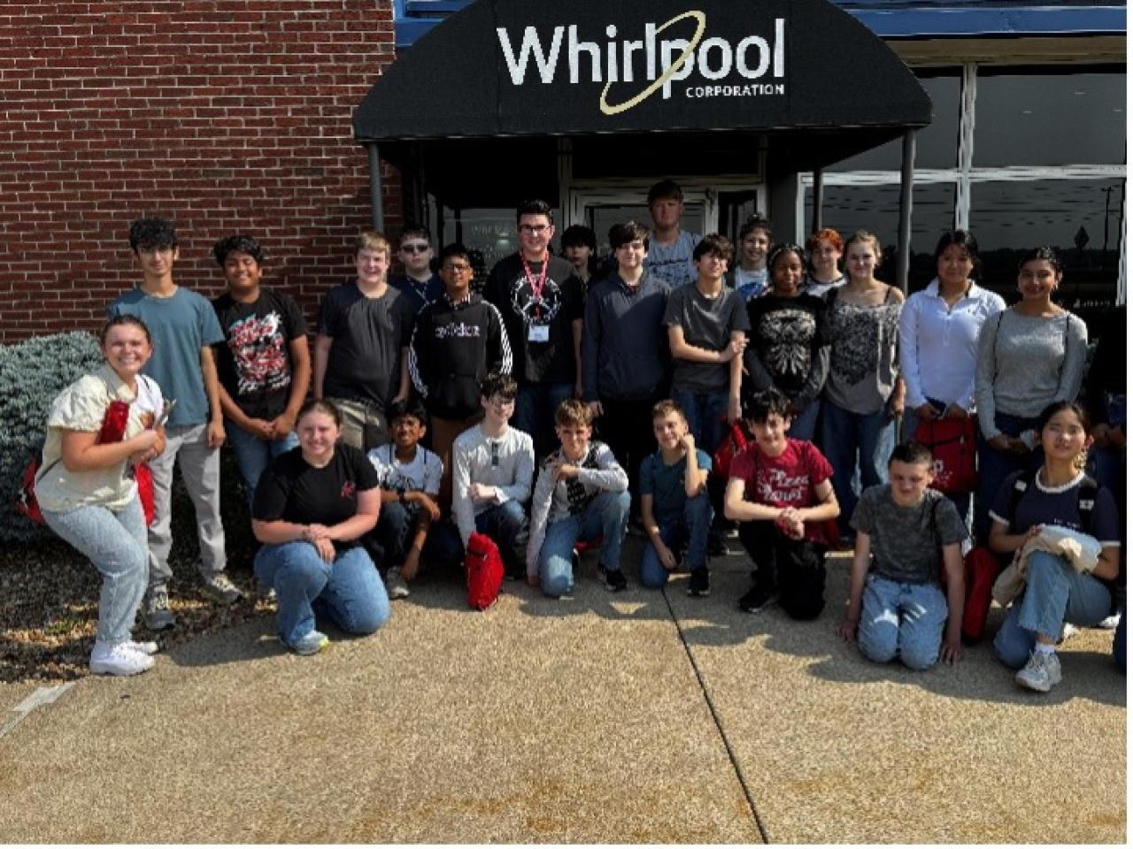 students posing in front of whirlpool