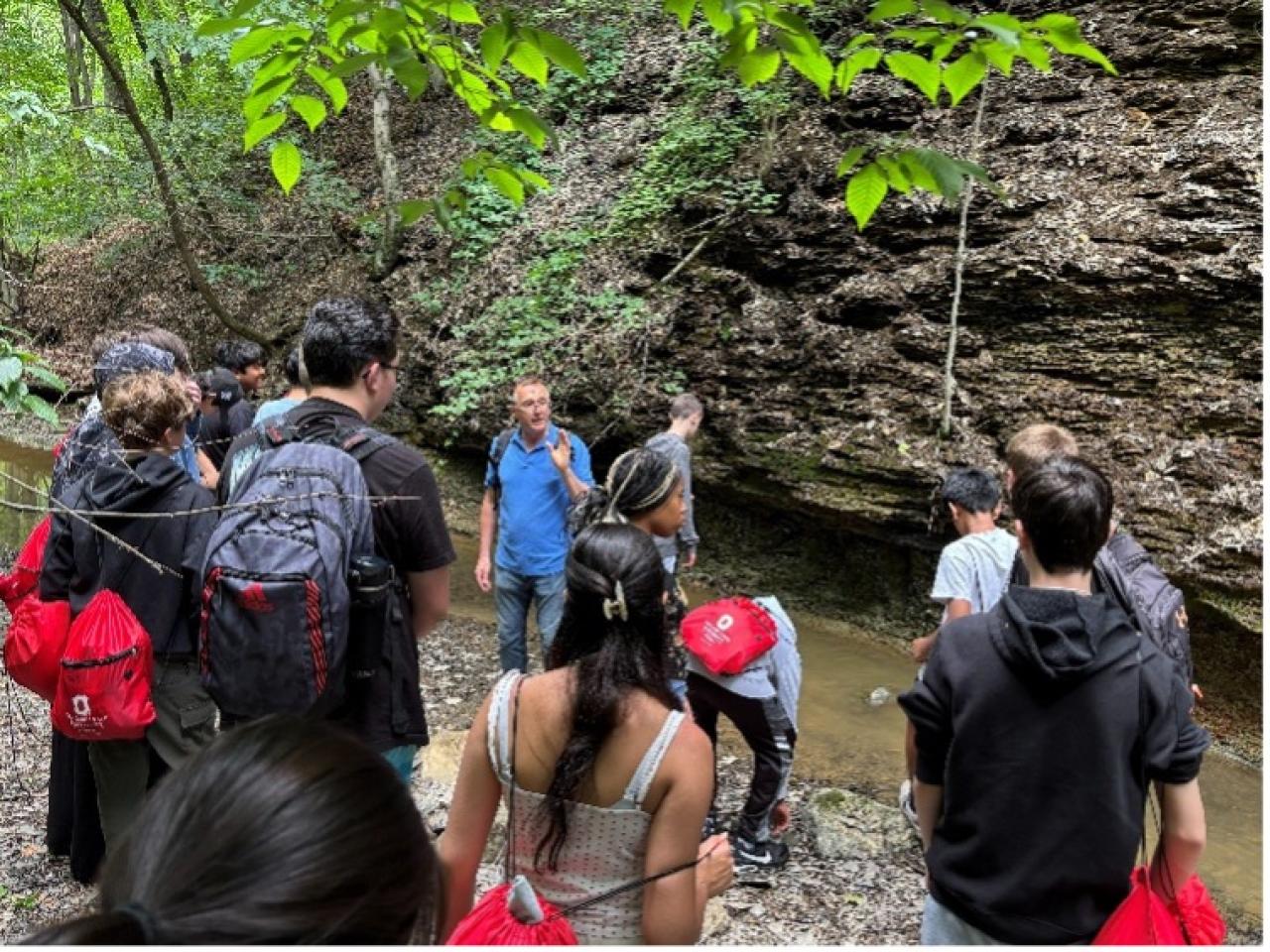 student by a creek learning