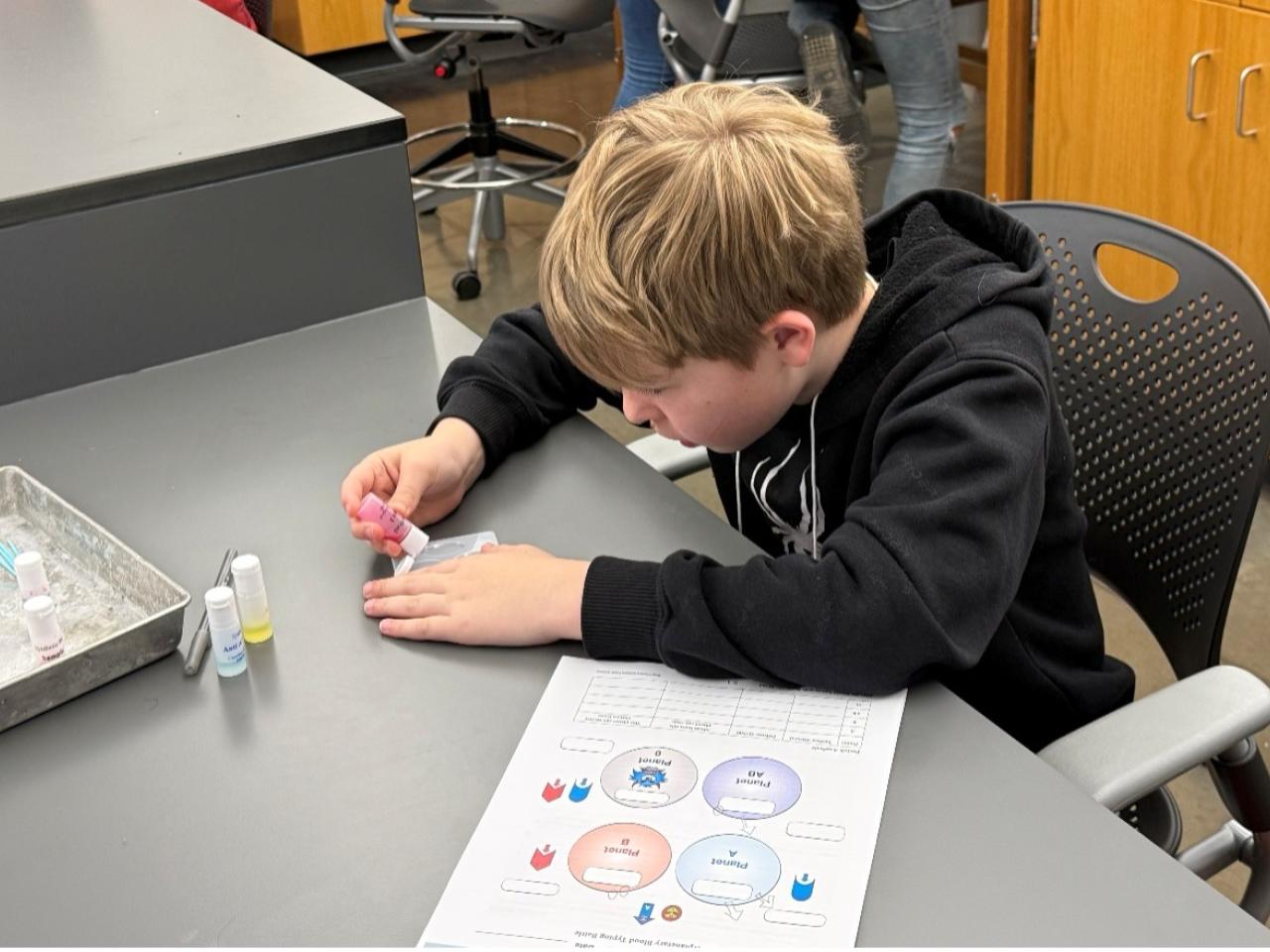 student working on blood typing
