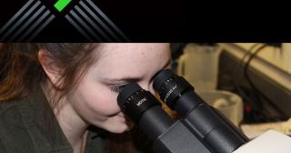 Bailey Lucas looking into Motic scientific microscope with Pelotonia logo edited into picture above her