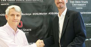 Dr. Scot Gray shaking hands with Ohio State Marion’s Dean & Director, Dr. Gregory S. Rose as he delivers check