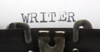 close up photo of typewriter writing word "writer"