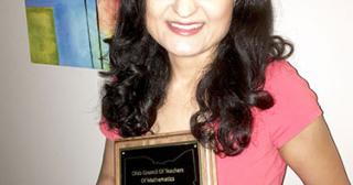 photo of Ohio State Marion Assistant Professor of Education, Aina Appova with he award