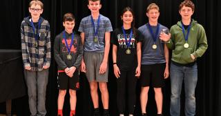 Six middle school students pose with award