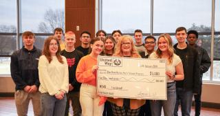 Group of young people holding a giant check