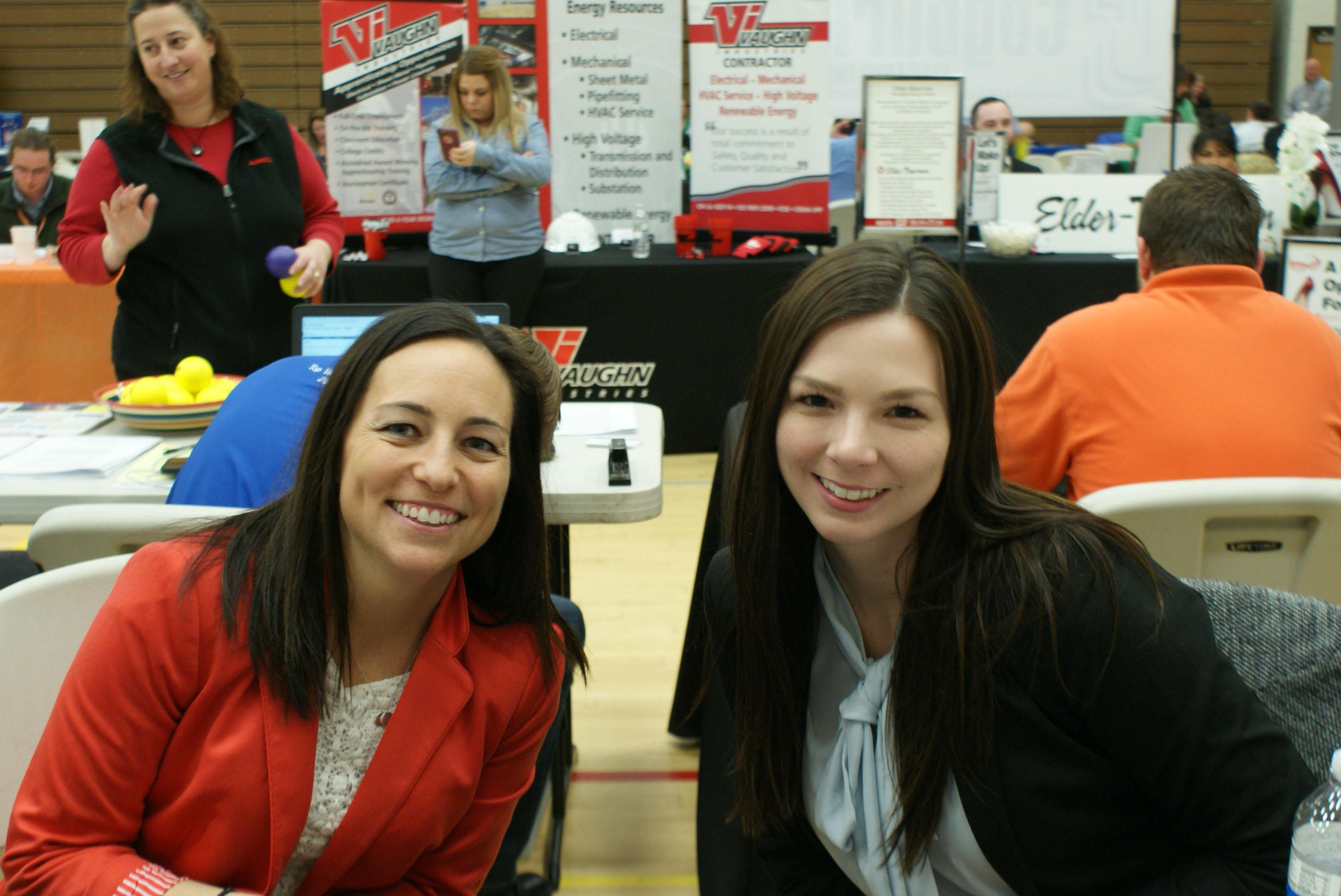 two women posing for photo at the job and internship fair