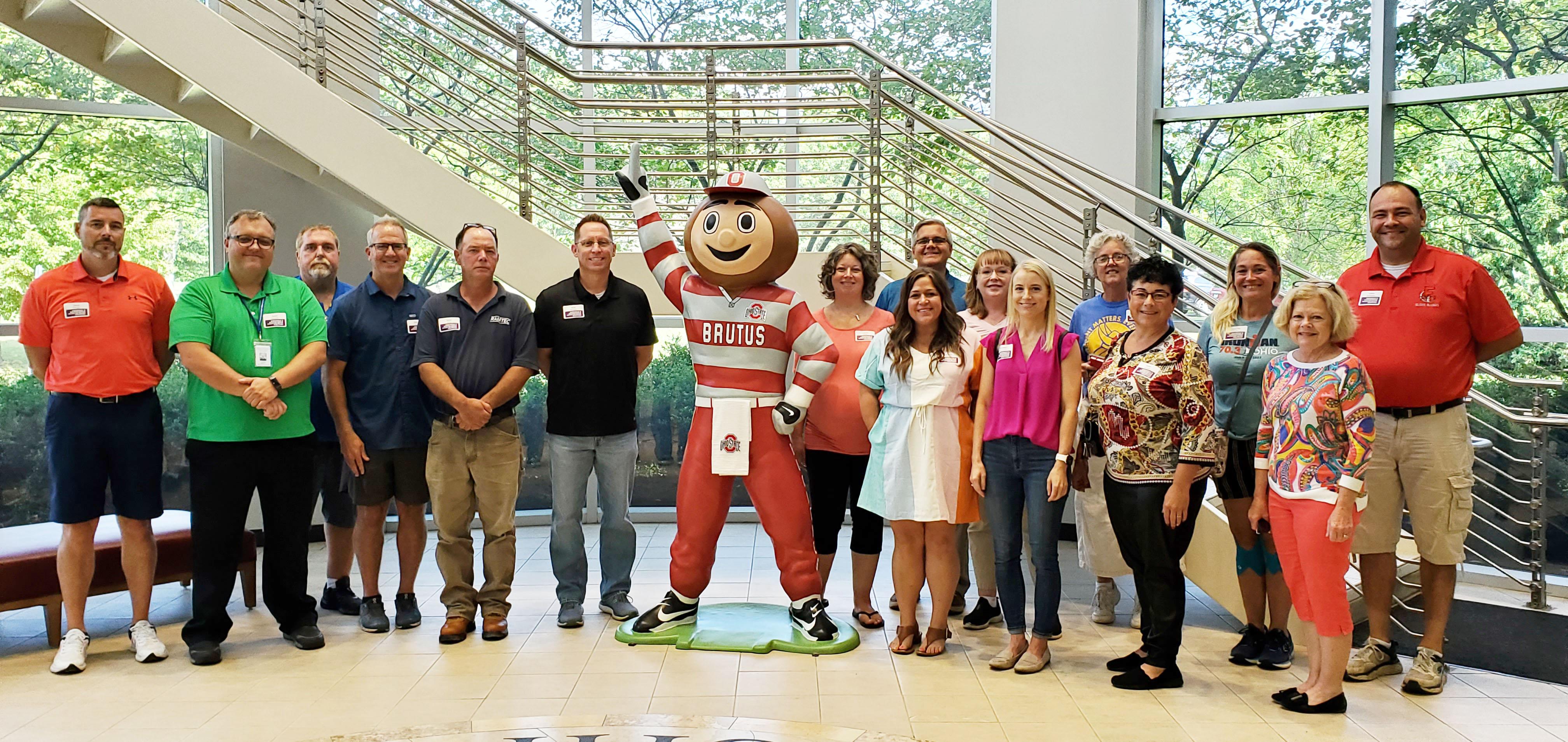 teachers participating in the Teacher Manufacturing Bootcamp standing around statue of Brutus