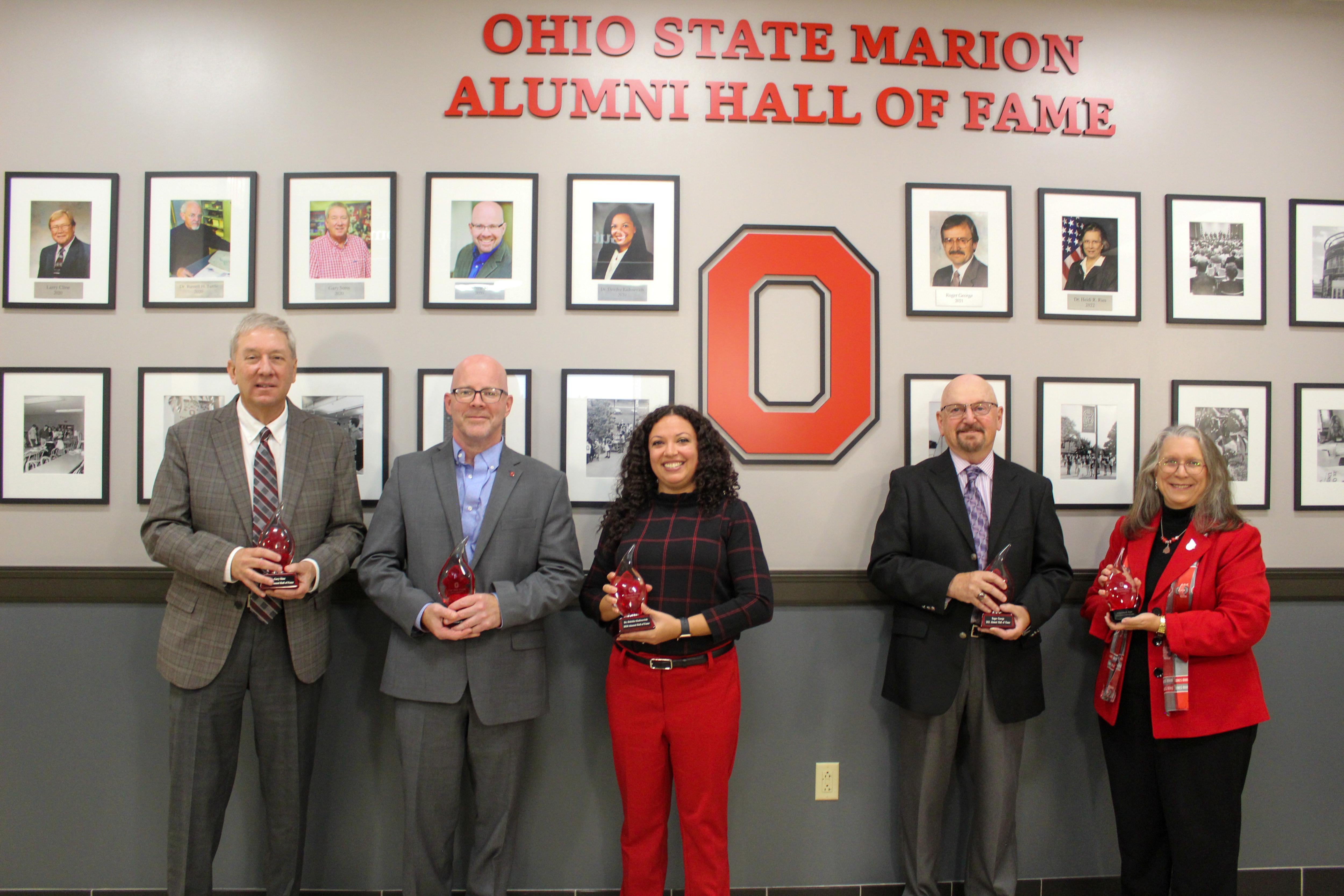 new members pictured in front of Ohio State Marion Alumni Hall of Fame wall
