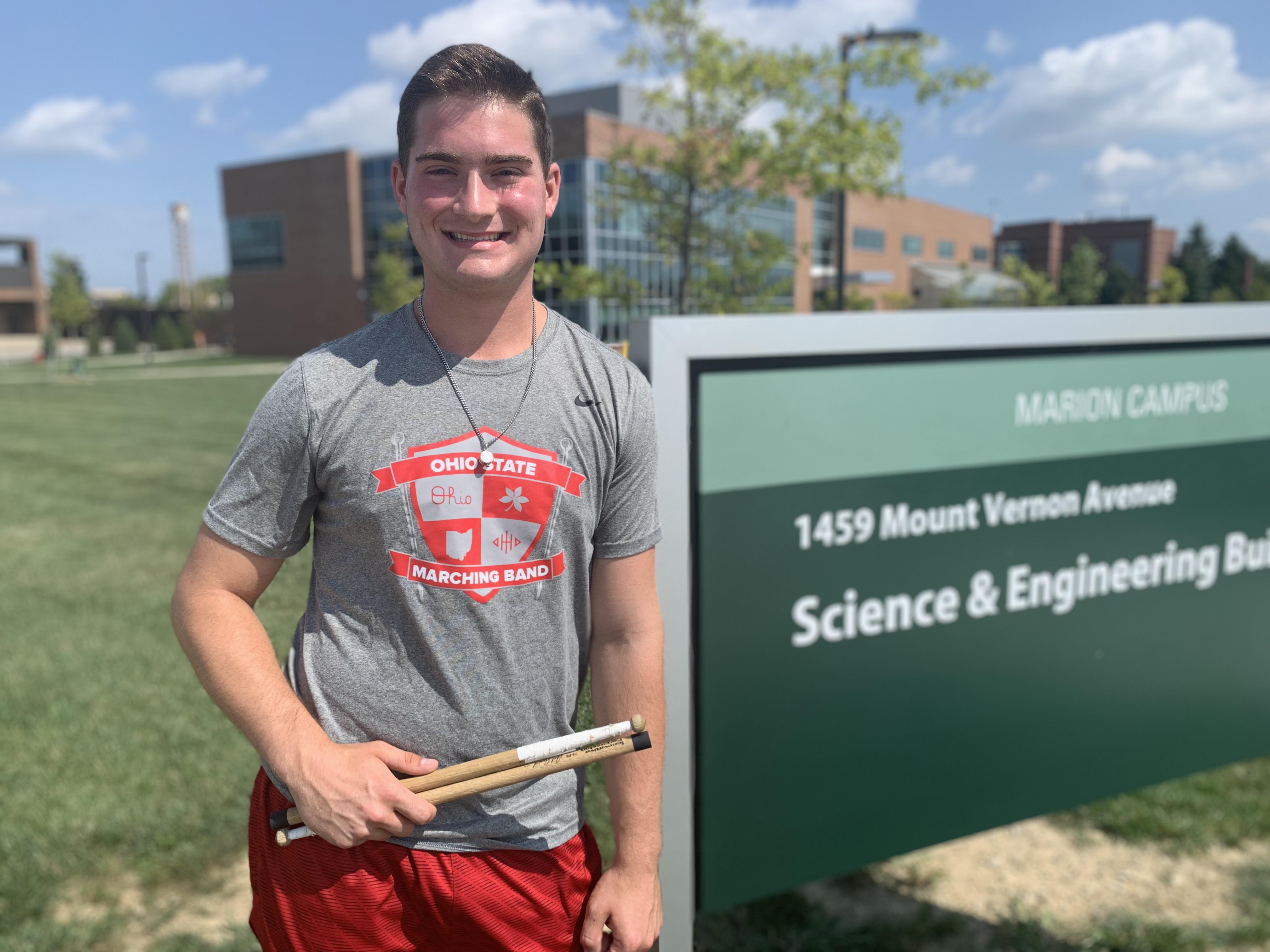 Ohio State Marion freshman Caleb Richardson posing with drum sticks on The Ohio State University at Marion campus