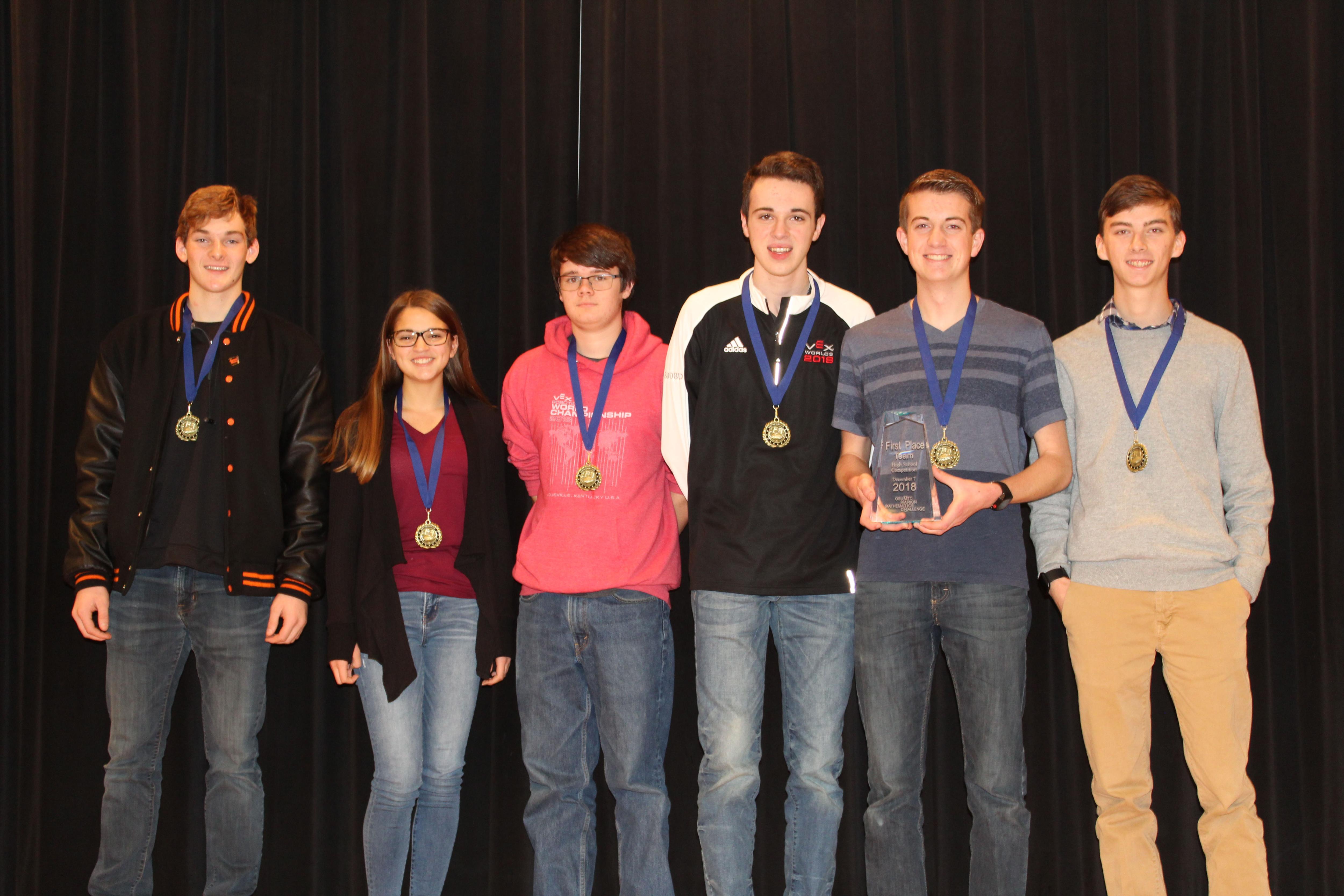 The winning team, six students from North Union High School, pictured with their medals and trophy