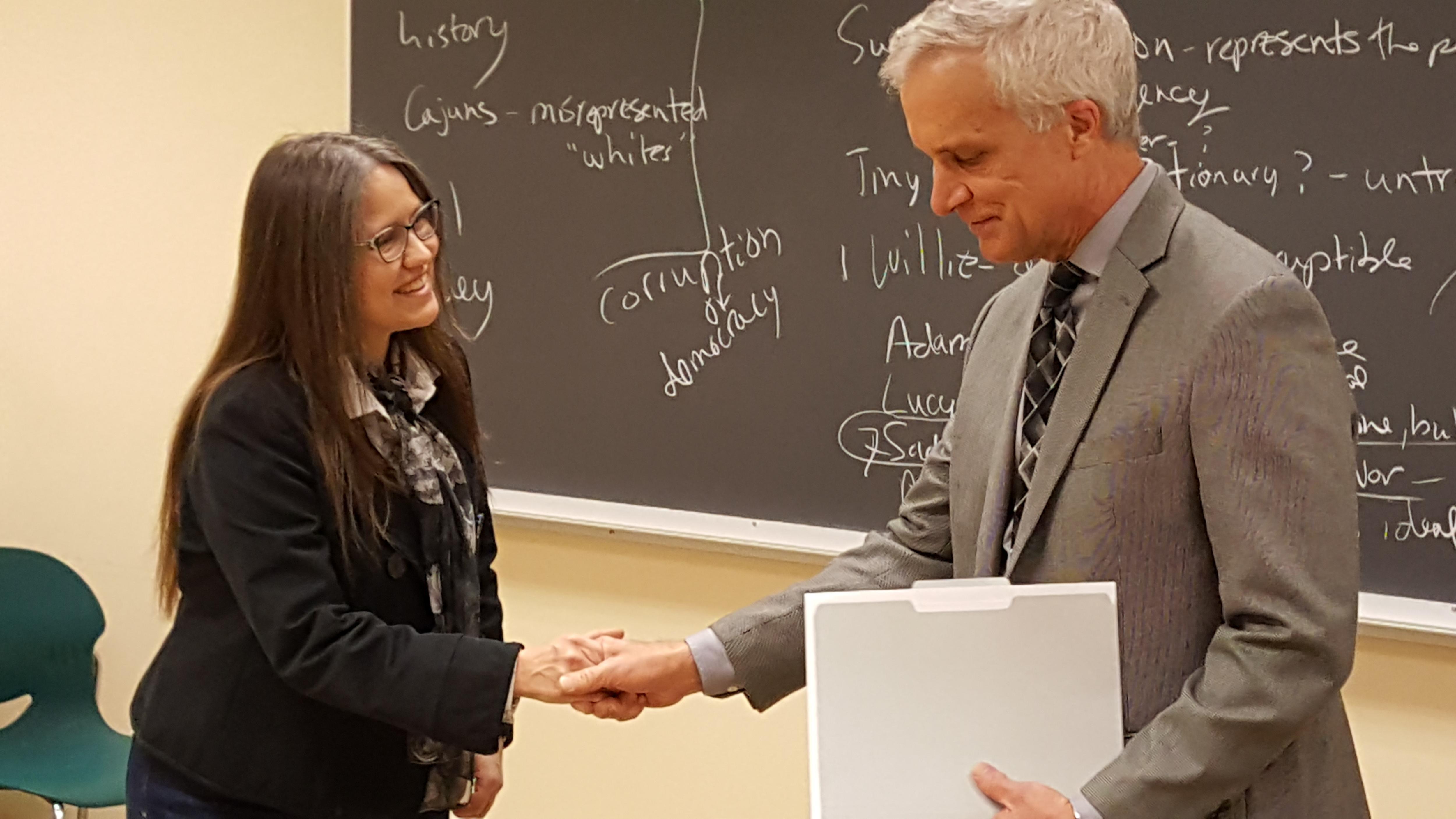 Peter Hahn, Dean of Arts and Humanities presents a $20,000 Ratner Award to Associate Professor of English Sara Crosby, the first regional campus professor to ever receive this prestigious award.