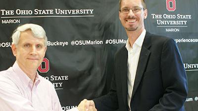 Dr. Scot Gray shaking hands with Ohio State Marion’s Dean & Director, Dr. Gregory S. Rose as he delivers check