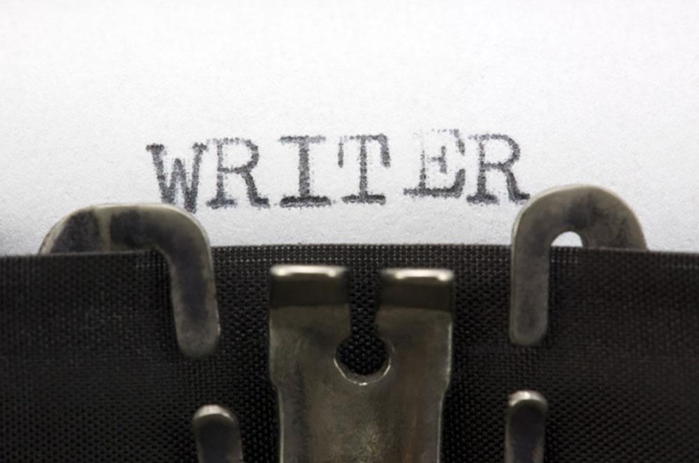 close up photo of typewriter writing word "writer"