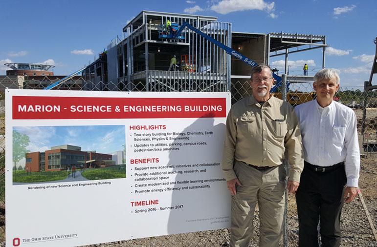 Ohio State Marion Dean and Director Dr. Greg Rose and local attorney Ron Cramer posing for picture in front of Ohio State Marion science and engineering building under construction