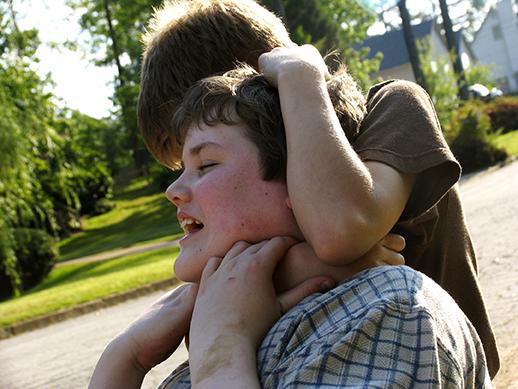 a child putting another child in a head lock