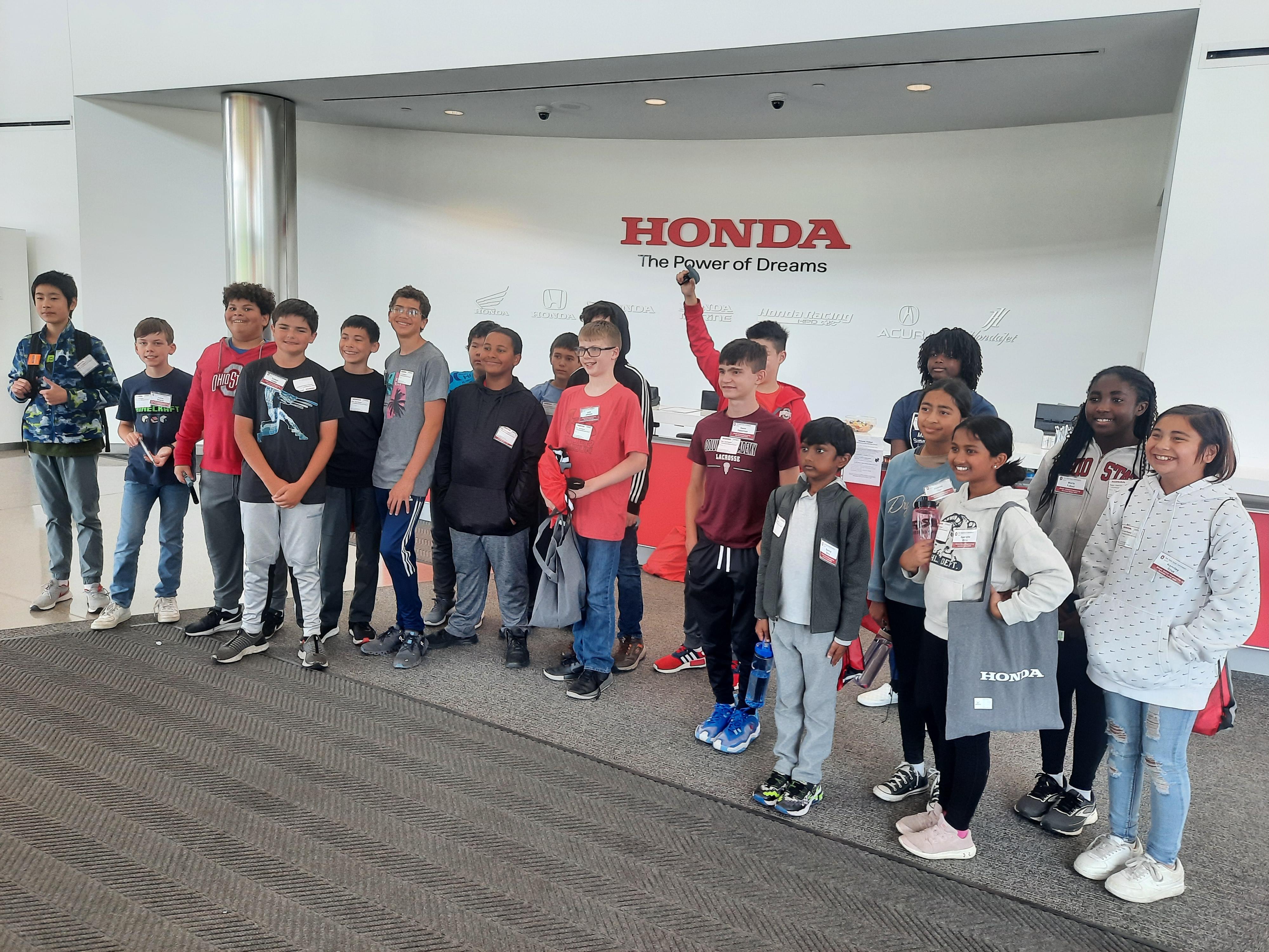 middle school students pose for a photo at honda