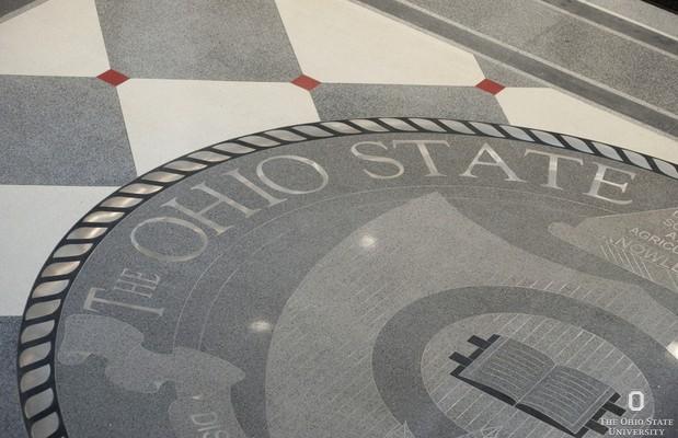 grey university seal and tile on floor