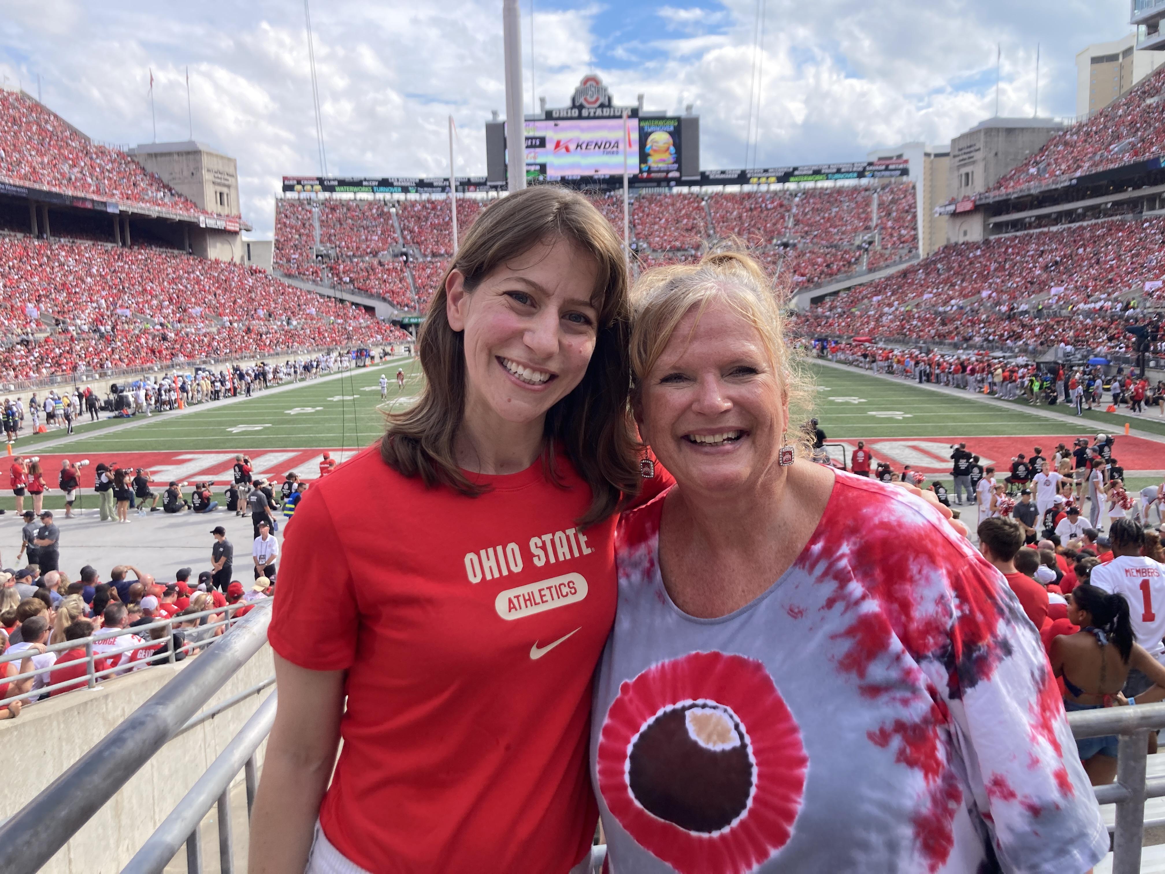 two women side by side in foreground with Ohio Stadium in the background