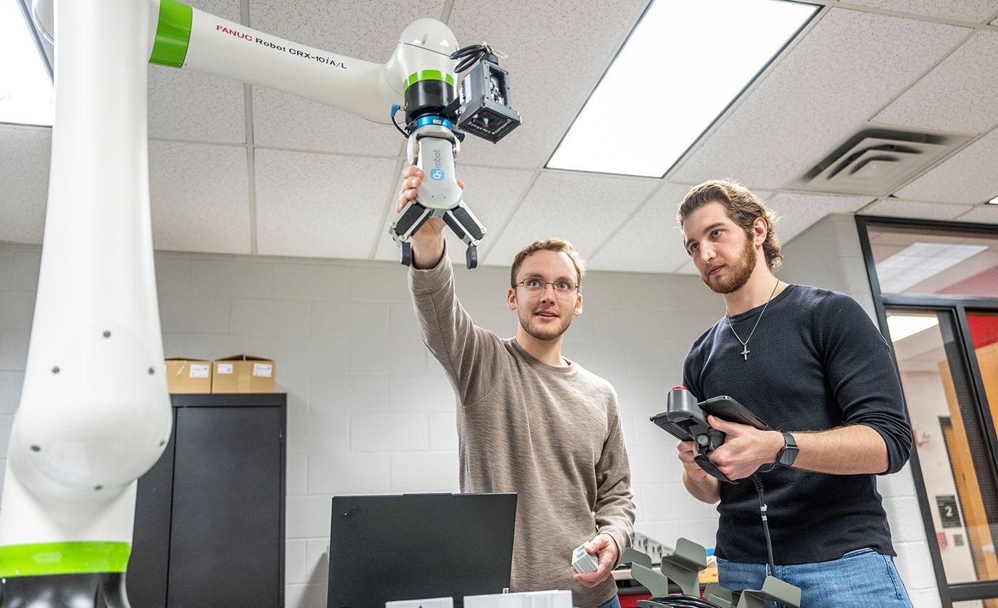 two young men work with technology
