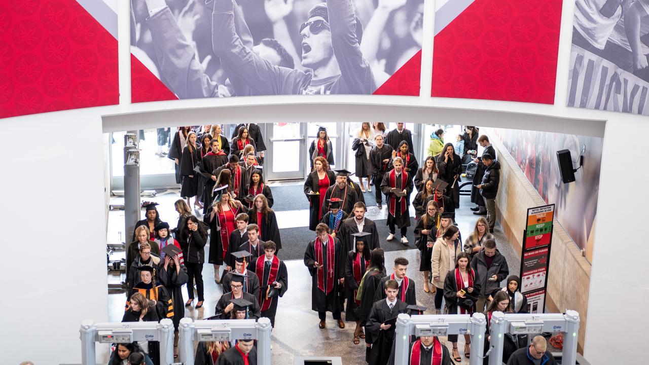 group of college graduates from above entering building