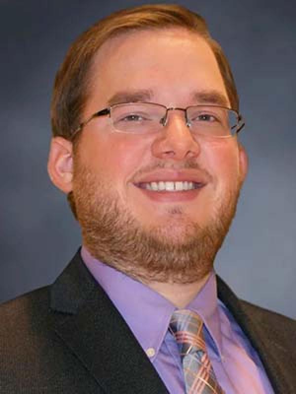 man in purple shirt and tie and suit