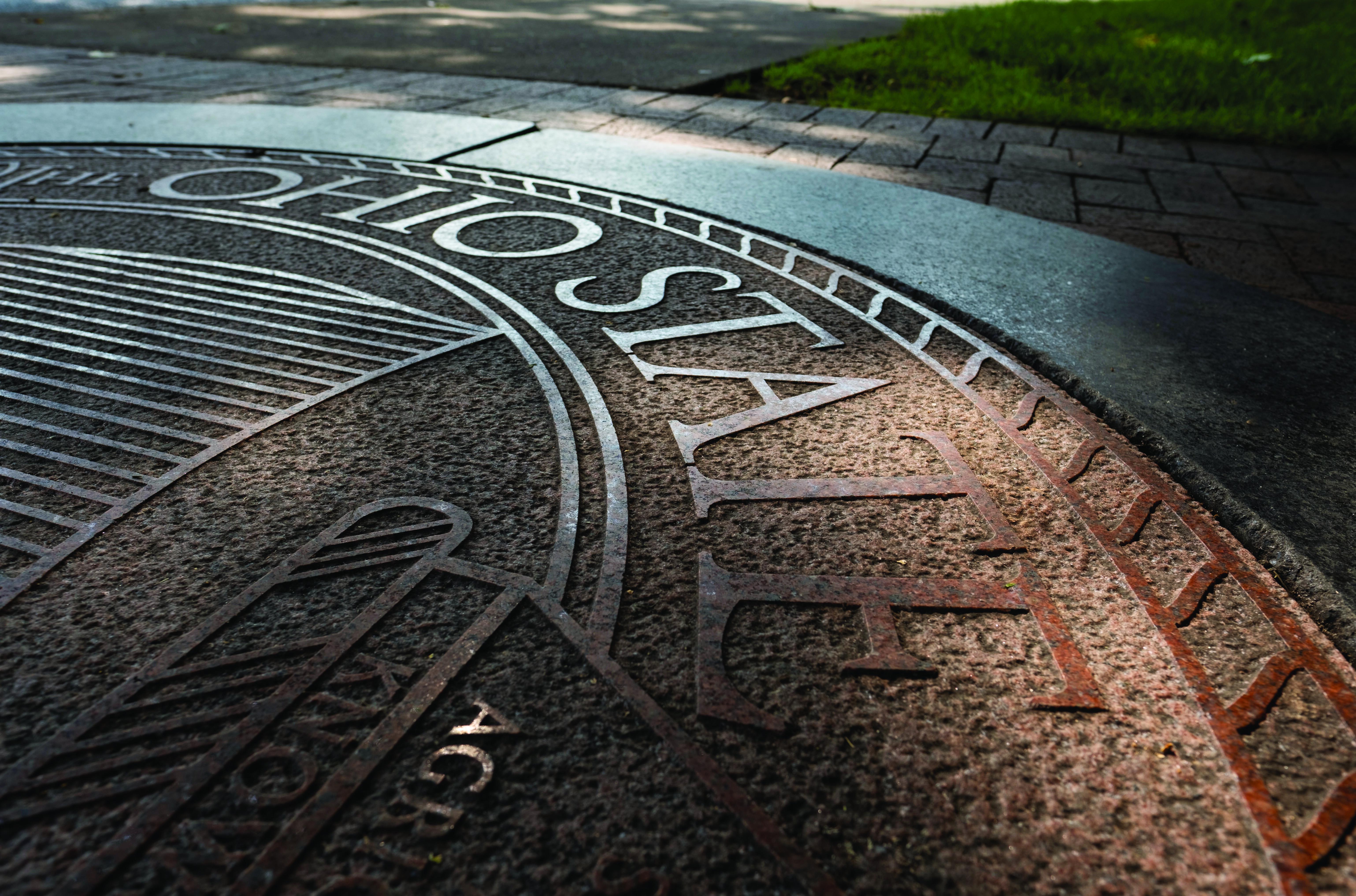 Ohio State seal outdoors at dusk
