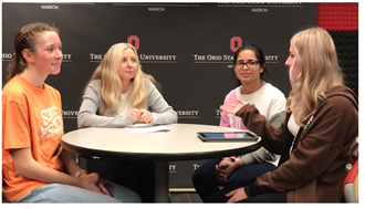 four women talking around a round table