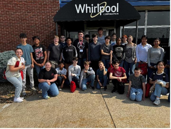 students posing in front of whirlpool