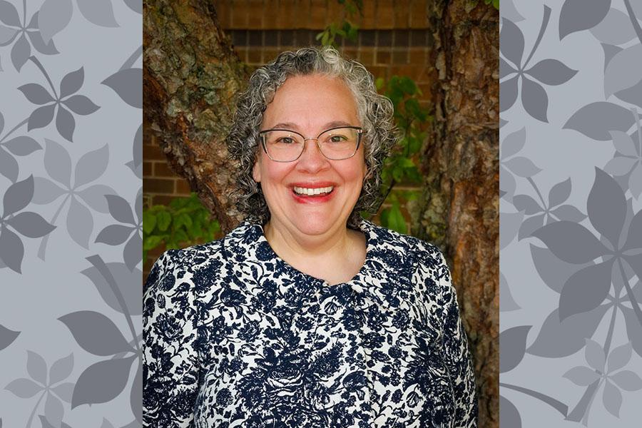 woman in glasses smiling with outdoor background 