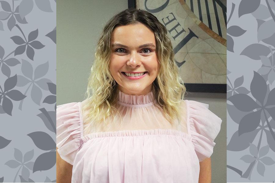 woman in pink blouse smiling