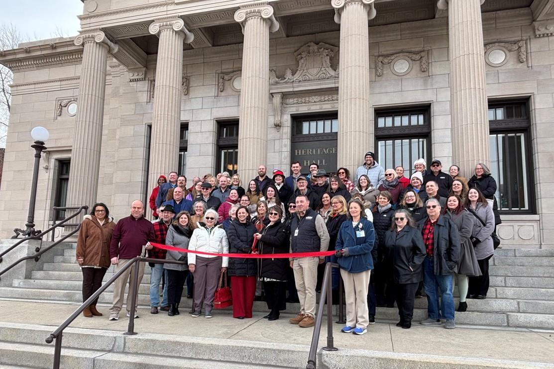 large group of people standing on museum steps