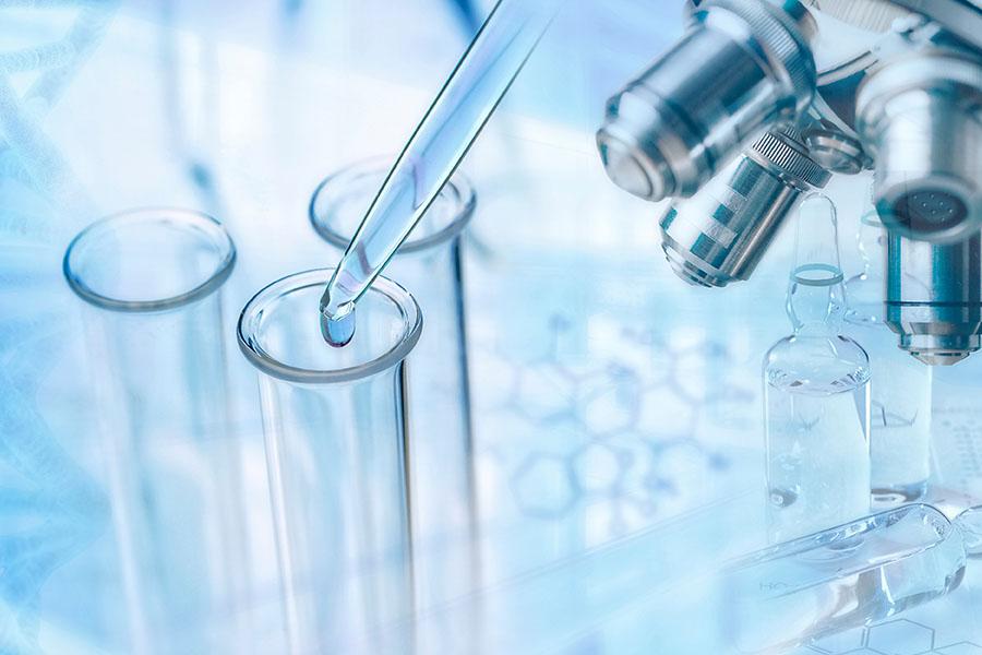 test tubes and microscope on light blue background