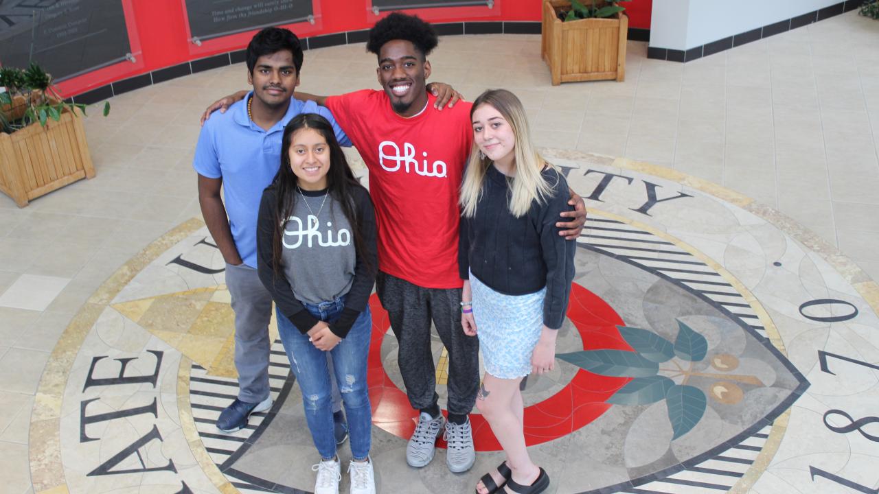 Four students pose in the lobby of Maynard Hall
